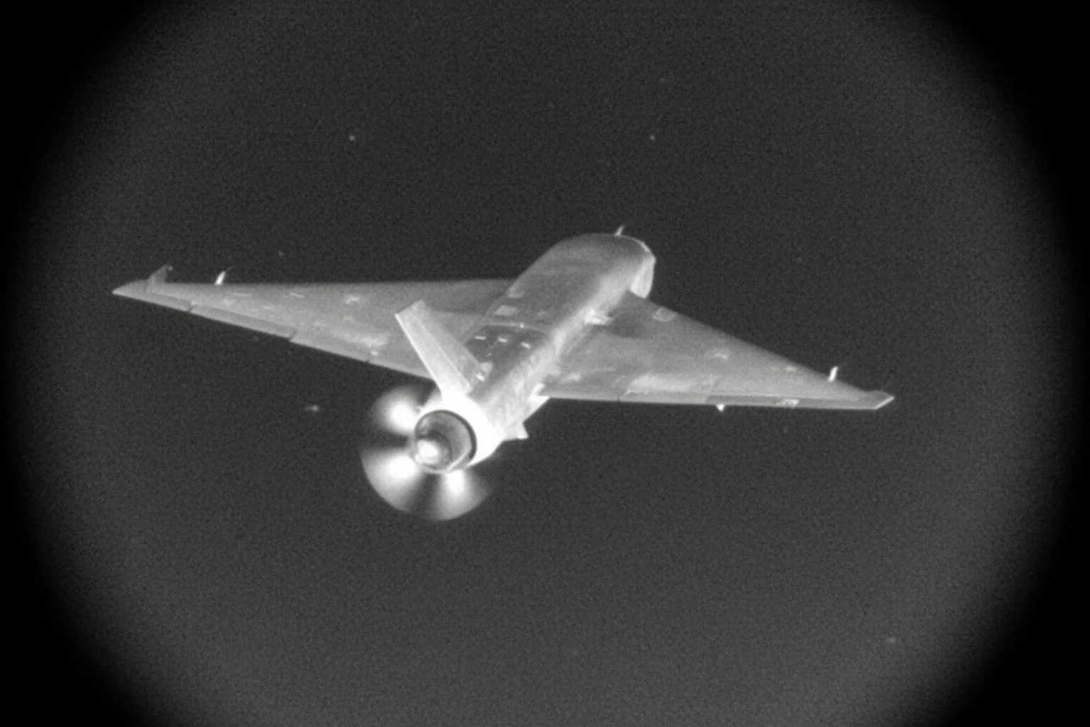 Thermal seeker view of a delta-wing attack drone